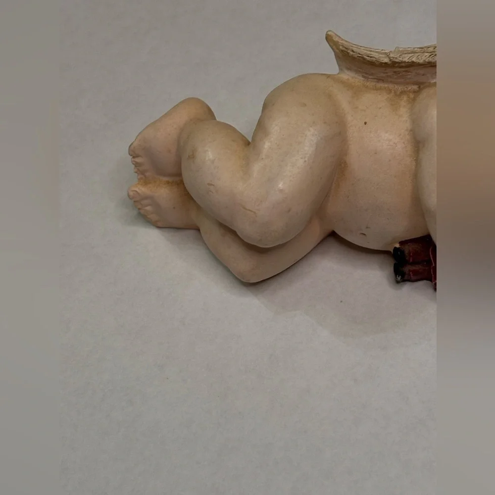 Sleeping Cherub Figurine holding a doll with Floral Crown